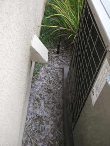 Part 2 of 2 figures- showing a noncompliant condensing unit clearance from a dryer vent at a different angle 